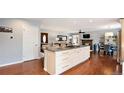 Spacious kitchen island with bar seating open to the dining and living areas at 6933 S Dahlia St, Centennial, CO 80122