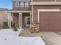 Front entrance of a two-story house with brick accents and a porch at 4936 Stoneham Ave, Castle Rock, CO 80104