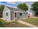 Gray painted home showing its well-manicured lawn at 201 4Th St, Frederick, CO 80530