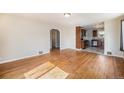 Open-concept living area with hardwood floors that seamlessly connects to the kitchen at 201 4Th St, Frederick, CO 80530