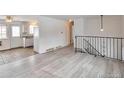 Inviting living room featuring wood floors and access to the kitchen at 9135 W Maplewood Ave, Littleton, CO 80123