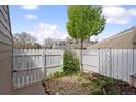 A beautiful backyard with an array of landscaping with garden rocks and a white picket fence at 8095 E Colorado Ave # 5, Denver, CO 80231