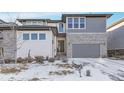 Charming home showcasing a two-car garage, stone accents, and manicured landscaping at 6801 S Valleyhead Ct, Aurora, CO 80016