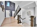Bright foyer featuring soaring ceilings, modern lighting, and beautiful hardwood floors at 6801 S Valleyhead Ct, Aurora, CO 80016