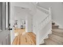 Bright foyer with hardwood floors and a staircase leading to the upper level at 740 Boxwood Ln, Longmont, CO 80503