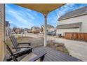 A covered front porch with patio chairs, offering a relaxing outdoor space at 740 Boxwood Ln, Longmont, CO 80503