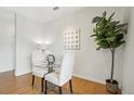 Cozy dining area with a glass table, upholstered chairs, a potted plant, and contemporary decor at 13456 Via Varra # 211, Broomfield, CO 80020