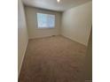 Neutral bedroom offering a serene atmosphere with soft carpeting and natural light through the window at 18901 E 99Th Pl, Commerce City, CO 80022