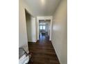 Inviting hallway with wood flooring leads to a bright living space, offering a warm welcome at 18901 E 99Th Pl, Commerce City, CO 80022