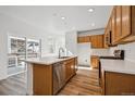 Bright kitchen features stainless appliances, light wood cabinets and an island with a sink at 3360 N Coolidge Way Way, Aurora, CO 80019