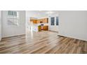Open-concept living space with beautiful hardwood flooring, natural light and views into the kitchen at 3360 N Coolidge Way Way, Aurora, CO 80019