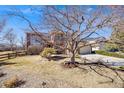 Beautiful two-story home with an inviting front yard, mature trees, and a three-car garage at 8941 Tuscany Ln, Highlands Ranch, CO 80130