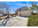 Beautiful two-story home with a spacious driveway, three-car garage, and well-maintained landscaping at 8941 Tuscany Ln, Highlands Ranch, CO 80130