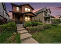Charming two-story home with inviting front porch, steps, and well-maintained landscaping at 5434 N Xenia St, Denver, CO 80238