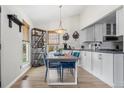 Eat-in dining area featuring modern light fixture, views from large windows, and seating for four at 803 W Lucerne Dr, Lafayette, CO 80026