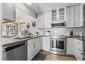 Well-lit kitchen featuring stainless steel appliances, white subway tile backsplash, and modern cabinetry at 803 W Lucerne Dr, Lafayette, CO 80026