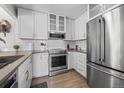 Modern kitchen featuring stainless steel appliances, quartz countertops, and ample cabinet space at 803 W Lucerne Dr, Lafayette, CO 80026