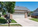 Beautiful home featuring a two-car garage, covered porch, driveway and lawn with a mailbox nearby at 5033 Goshawk Ct, Brighton, CO 80601
