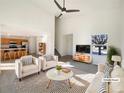 Virtually staged living room with vaulted ceilings, neutral colors, and a view of the kitchen at 1090 Quail Cir, Brighton, CO 80601