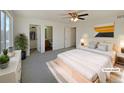 Virtually staged main bedroom with ensuite bathroom and walk-in closet at 1090 Quail Cir, Brighton, CO 80601