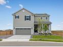 Charming two-story home with a well-manicured lawn and an attached two-car garage at 17424 E 90Th Pl, Commerce City, CO 80022