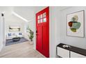Inviting entryway with a bright red door, skylight, and modern decor, leading into a cozy living space at 2767 W 38Th Ave, Denver, CO 80211