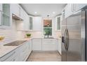 Updated kitchen features white cabinets, stainless steel appliances, and under-cabinet lighting at 2767 W 38Th Ave, Denver, CO 80211