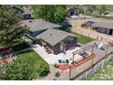 Aerial view of house with brick and siding, backyard patio, pergola, and landscaping at 16225 W 74Th Dr, Arvada, CO 80007
