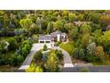 Aerial view of a stunning modern home surrounded by mature trees and a circular driveway at 5160 S Franklin St, Greenwood Village, CO 80121