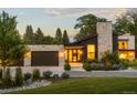 Inviting front entrance with a stone accent wall, well-manicured lawn, and a two-car garage at 5160 S Franklin St, Greenwood Village, CO 80121