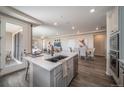 Open kitchen features island, breakfast bar, and access to the backyard at 21937 E 51St Dr, Aurora, CO 80019