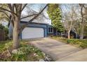 Quaint one-story house showcasing a two-car garage, a concrete driveway, and a landscaped front yard at 247 Regal St, Louisville, CO 80027