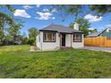 A cozy house on a large lawn. The home has black trim and a chimney at 11842 W 14Th Ave, Lakewood, CO 80401