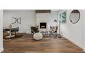 Bright living room featuring a brick fireplace, and dark wood floors and contemporary decor at 11842 W 14Th Ave, Lakewood, CO 80401