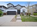 Charming two-story home featuring a gray garage door, modern siding, and a well-manicured front lawn at 10934 Touchstone Loop, Parker, CO 80134