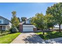 Well-maintained two-story house with a brick-accented facade, a two-car garage, and a lush front yard at 5667 W 109Th Cir, Westminster, CO 80020