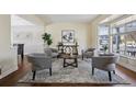 Cozy living room with hardwood floors, neutral walls, a bay window, and seating arrangement at 5667 W 109Th Cir, Westminster, CO 80020