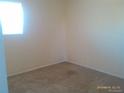 A cozy bedroom features neutral paint, carpet, and a bright window at 10762 E Exposition Ave. Ave # 137, Aurora, CO 80012