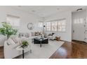 Inviting living area featuring a white sofa, decorative pillows, and a modern coffee table at 869 Bluestem Ln, Louisville, CO 80027