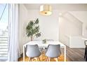 Cozy dining area with a modern table, stylish chairs, and natural light from the nearby window at 5527 W 11Th Pl, Lakewood, CO 80214