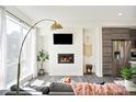 Inviting living room featuring a fireplace, TV, and modern decor at 5527 W 11Th Pl, Lakewood, CO 80214