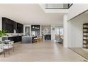 Spacious open-concept kitchen with dark cabinets, a large island with seating, and modern appliances at 5831 Galena St, Denver, CO 80238