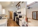 Functional kitchen features black appliances and ample cabinet space at 671 Brentwood St, Lakewood, CO 80214