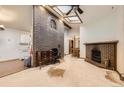 Open living room features skylights and a fireplace, perfect for cozy evenings at 671 Brentwood St, Lakewood, CO 80214