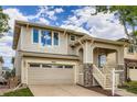Beautiful two-story home with a covered front porch, stone accents, attached garage, and lush landscaping at 10626 Cherrybrook Cir, Highlands Ranch, CO 80126