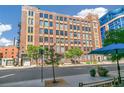 Street view of brick building featuring many windows, trees, and sidewalk at 1863 Wazee St # 6B, Denver, CO 80202