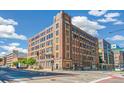 Full exterior shot of the brick building with many windows on a sunny day, located at a street corner at 1863 Wazee St # 6B, Denver, CO 80202