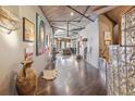 Spacious hallway with concrete ceilings, artwork, and hardwood floors leads into a living space at 1863 Wazee St # 6B, Denver, CO 80202