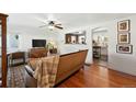 Inviting living room with hardwood floors, stylish decor, and an open view into the kitchen at 4315 S Elati St, Englewood, CO 80110