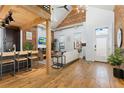 Open living area with exposed brick, hardwood floors, and a modern kitchen at 3260 Curtis St, Denver, CO 80205